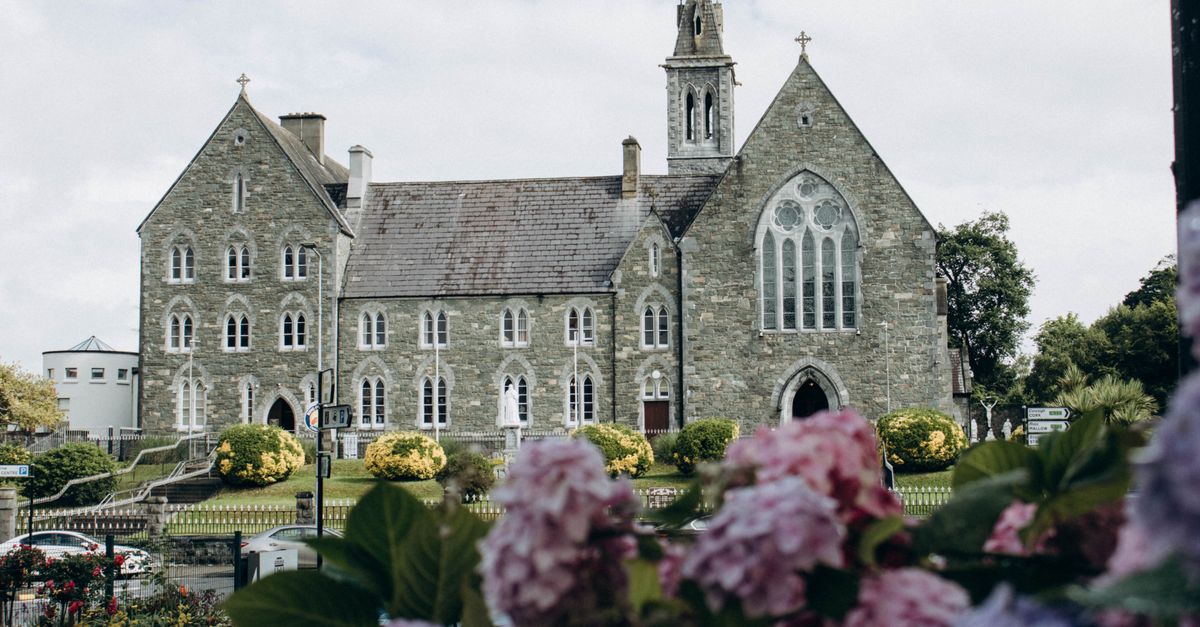 Majestic medieval church with blooming flowers in Killarney, Ireland.